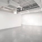 White walls and grey cement floors in the interior space